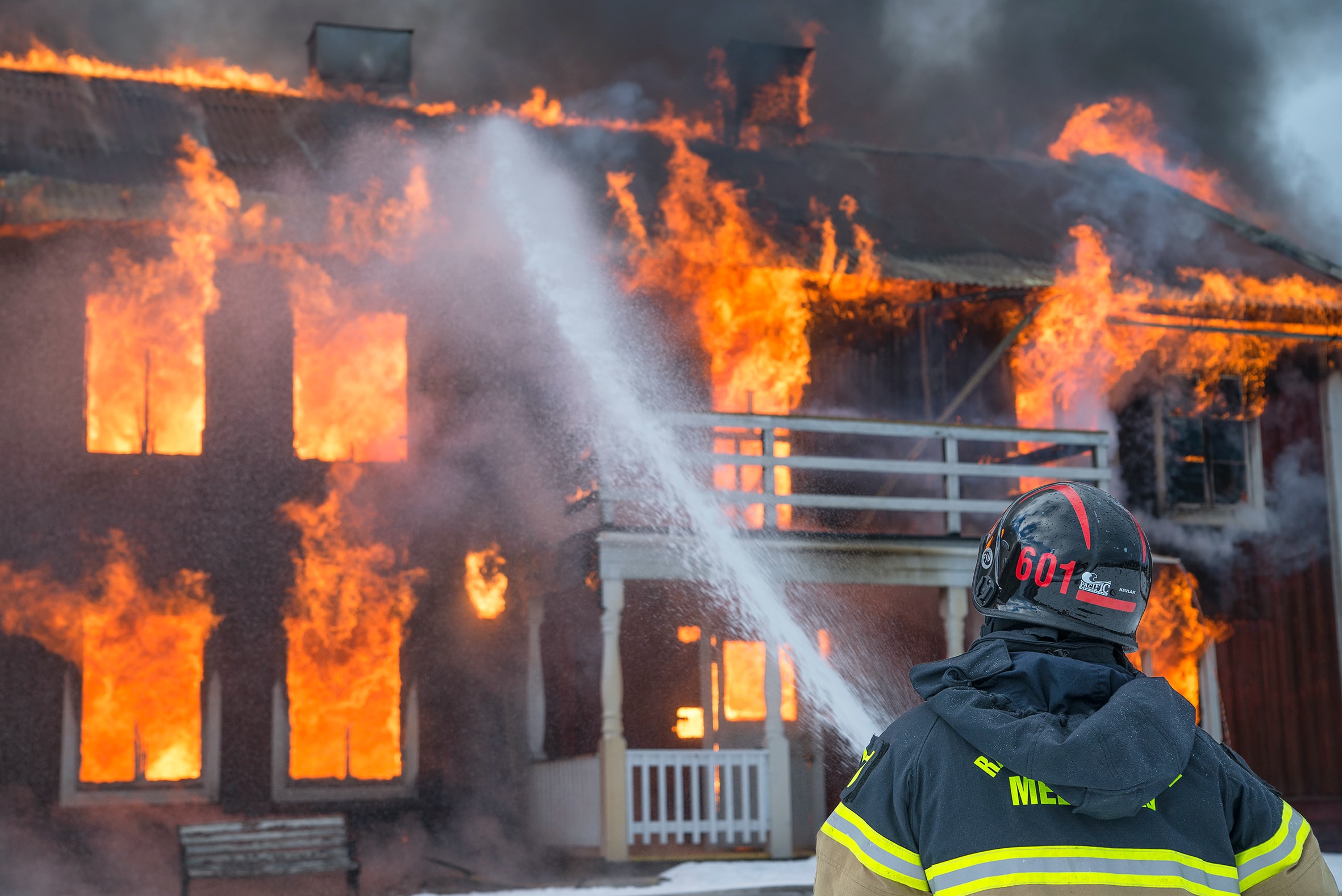 A firefighter trying to put out a fire in a resident home. ONESource supports restoration work for any disaster